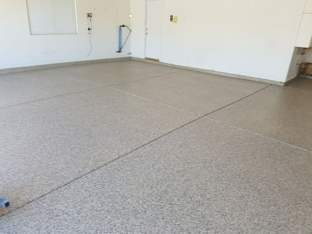 Clean, polished garage floor with textured finish and white walls in well-lit space.