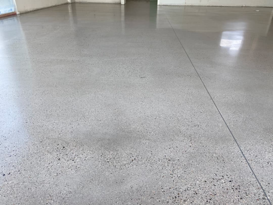 Polished concrete floor with a smooth, reflective surface and minimal imperfections.