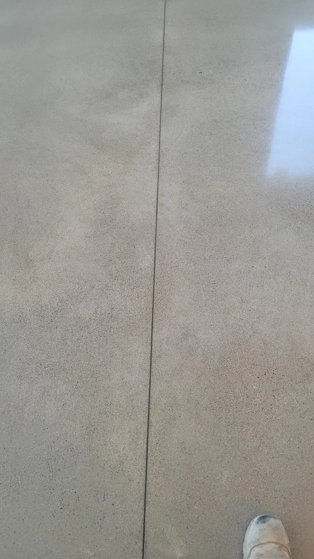 Polished concrete floor with subtle texture and a visible joint line.