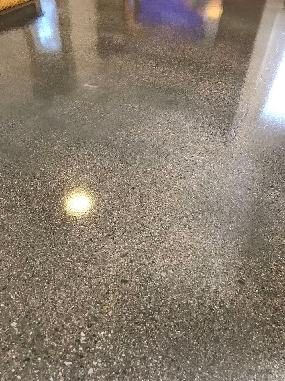 Glossy polished concrete floor reflecting light for a modern aesthetic.