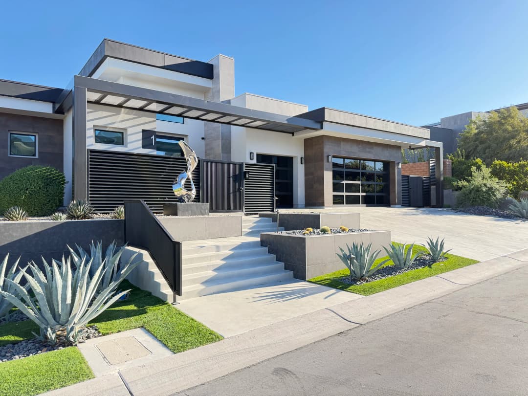 Modern luxury home exterior with striking landscaping and contemporary architecture.