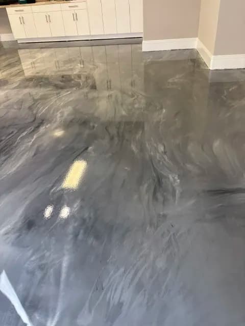 Gleaming gray and white marble epoxy floor in modern interior space.